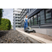 Karcher KM 70/30 C Bp sweeping a paved walkway by a curb