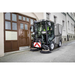 Karcher MC 80 sweeping a narrow sidewalk by a doorway