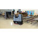 Tomcat PRO rider scrubber cleaning a school cafeteria floor