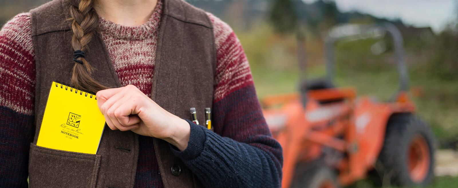 Woman putting notebook in pocket