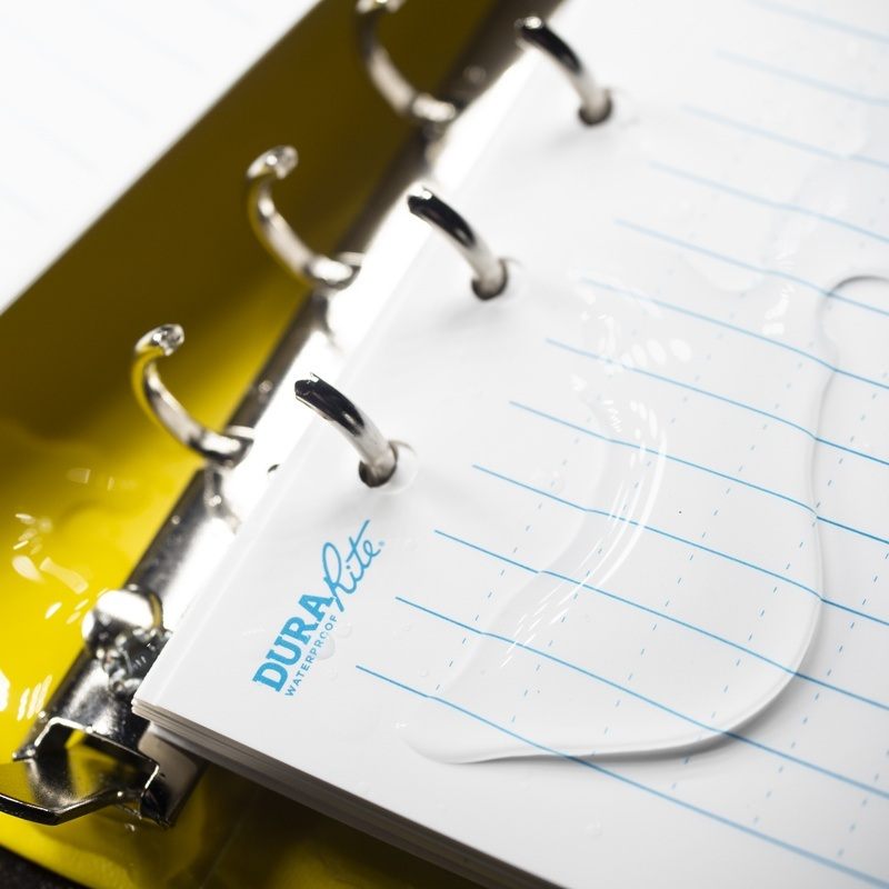 Open ring binder containing wet DuraRite loose leaf.