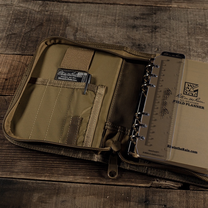 Open planner kit containing all-weather pen, writing guard, ruler, and loose leaf.