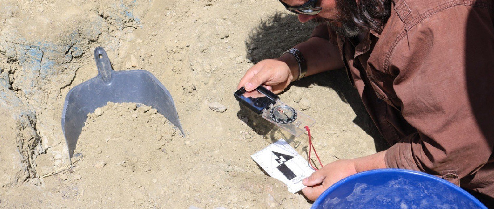 Director of Fossils using a Rite in the Rain photo scale.