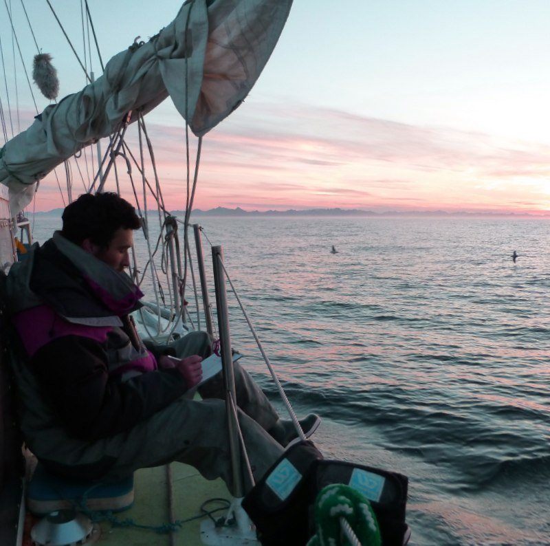 person on sail boat writing