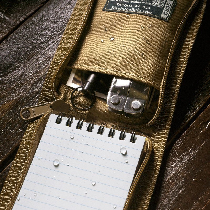 Open top Bound notebook cover containing a wet notebook and small gear.